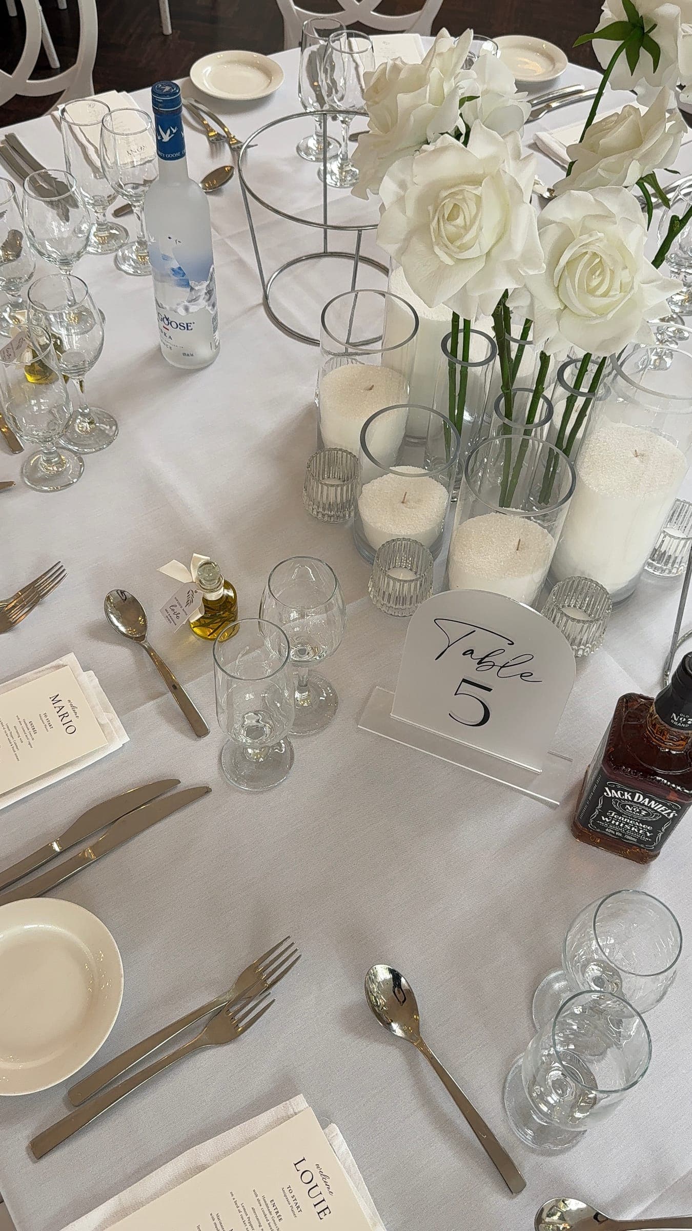 Elegant wedding table setting with white roses and candles