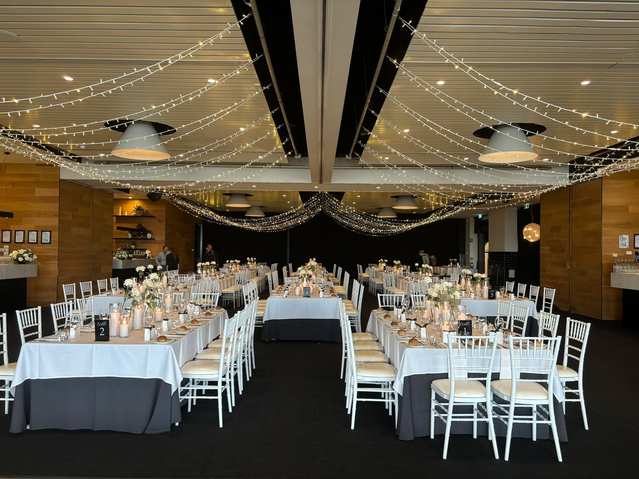 Full reception venue with fairy lights overhead