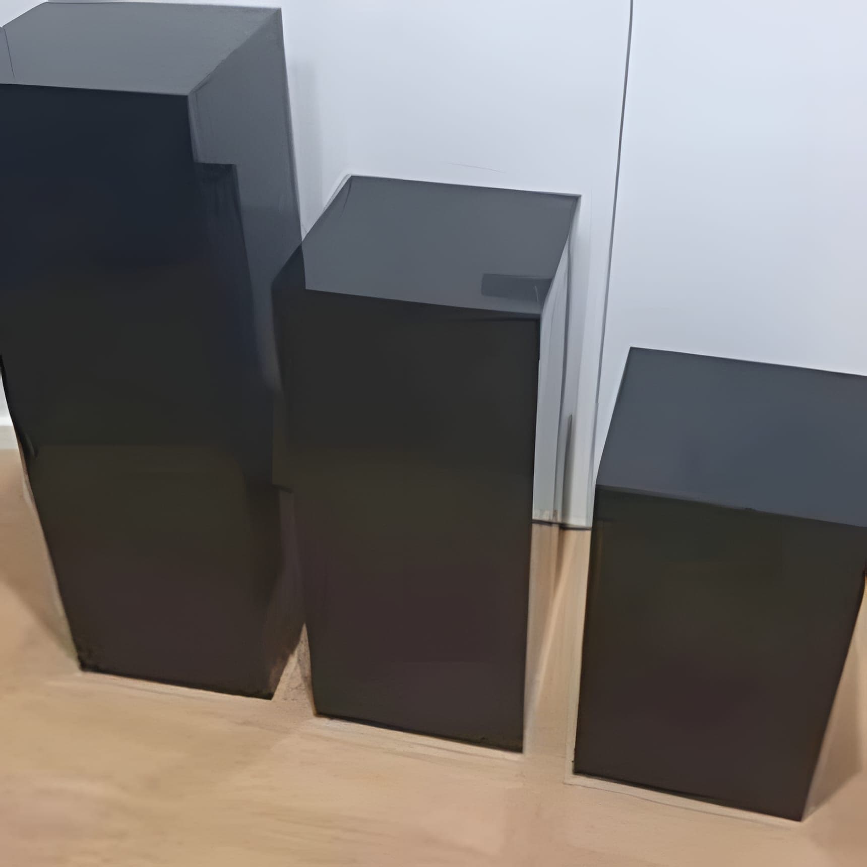 Set of three square black acrylic plinths